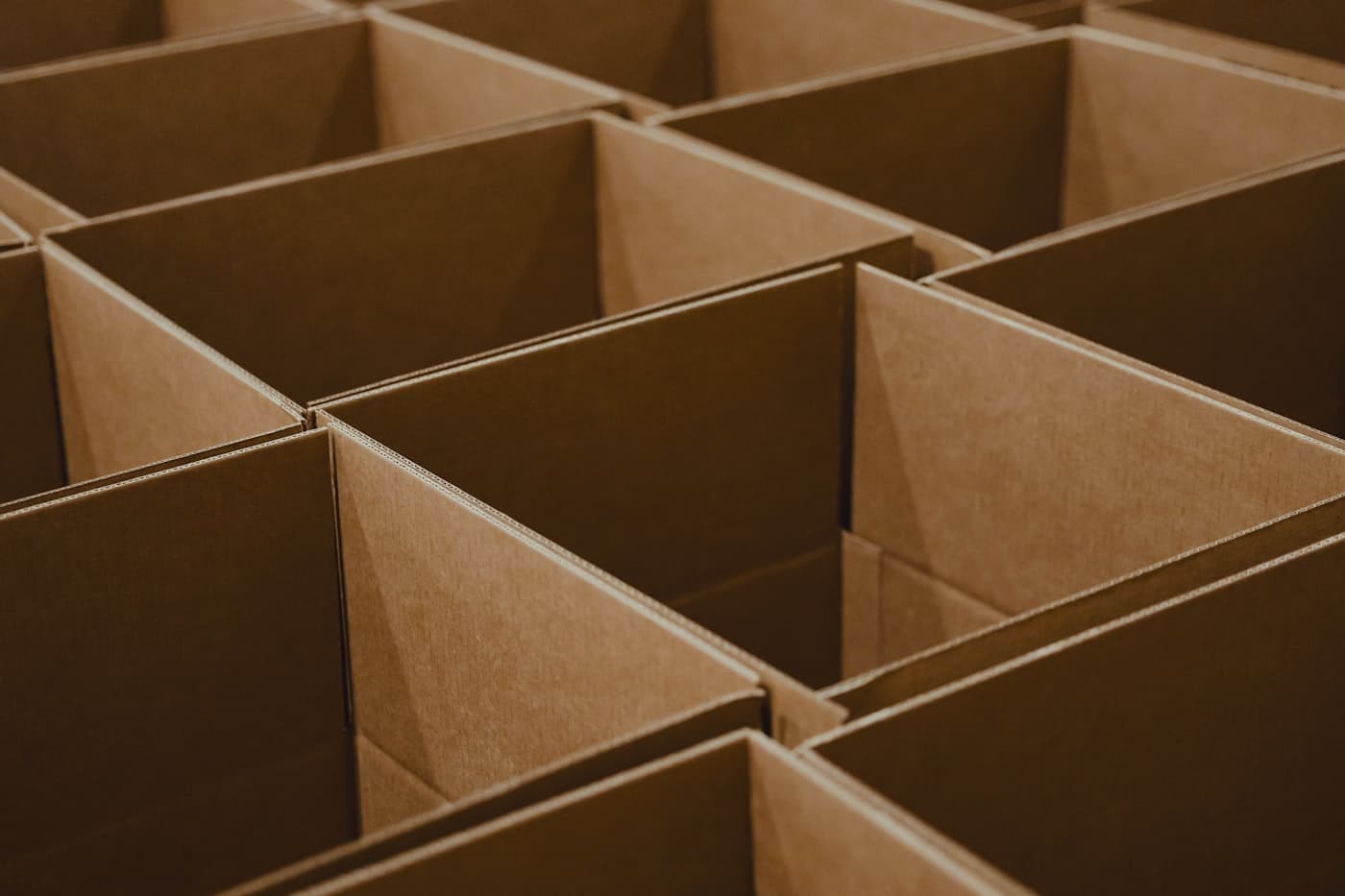 Several open brown corrugated export boxes