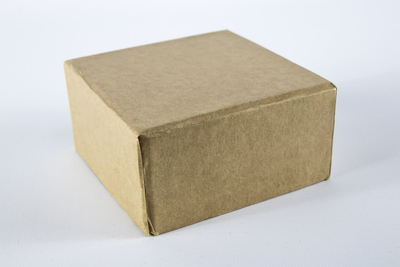 A heavy-duty brown corrugated carton on a white surface